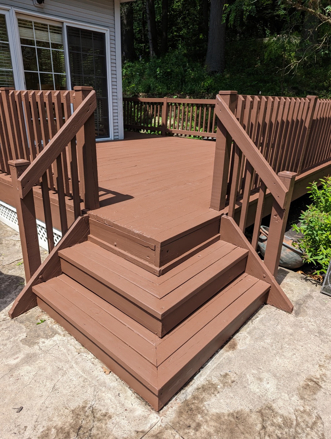 Professional deck painting on residential stairs