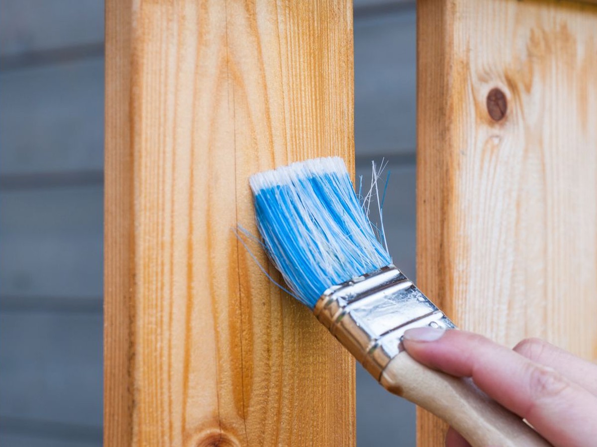 Applying stain to outdoor wood decking and railing
