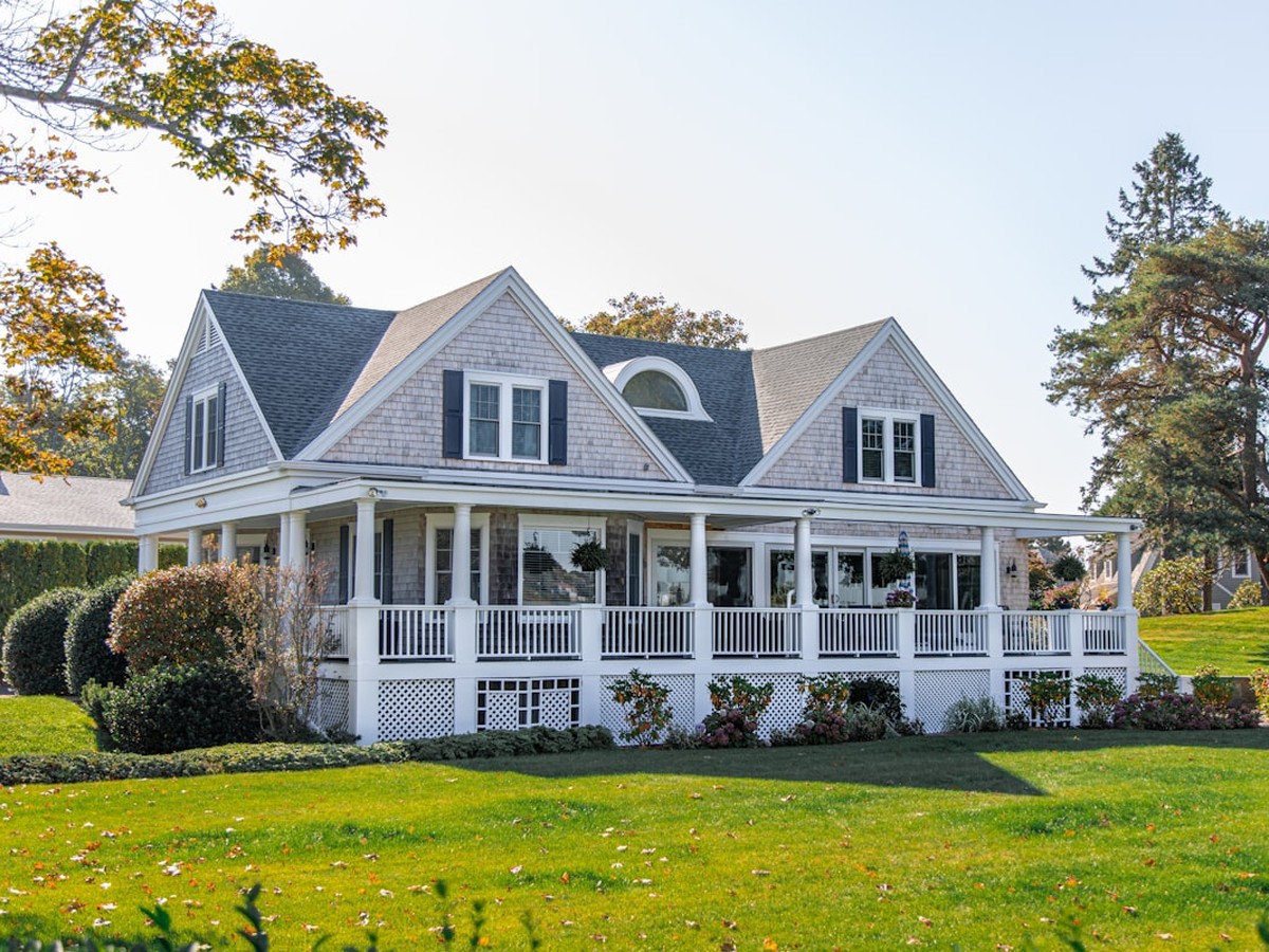 Gray shingle home with wraparound porch in a Greater Rochester neighborhood