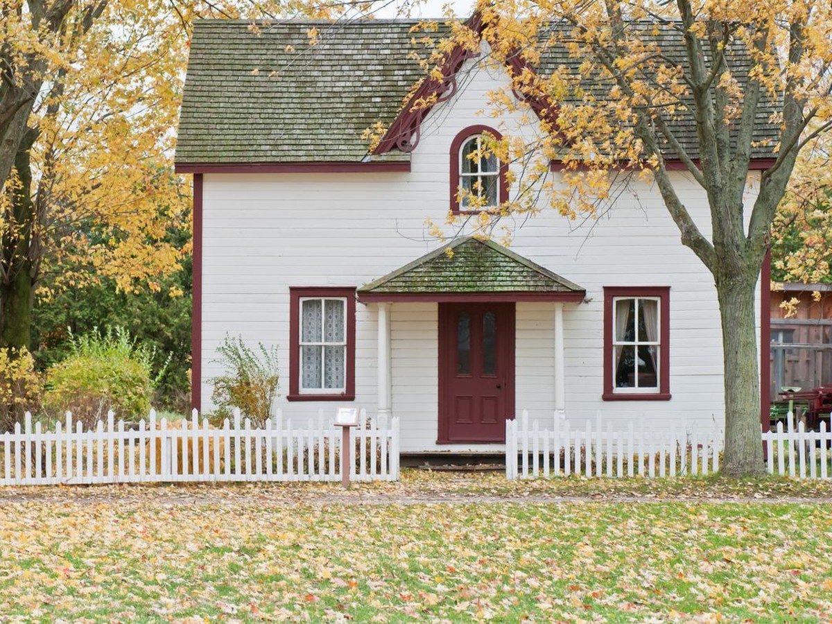 Historic upstate New York home surrounded by autumn foliage